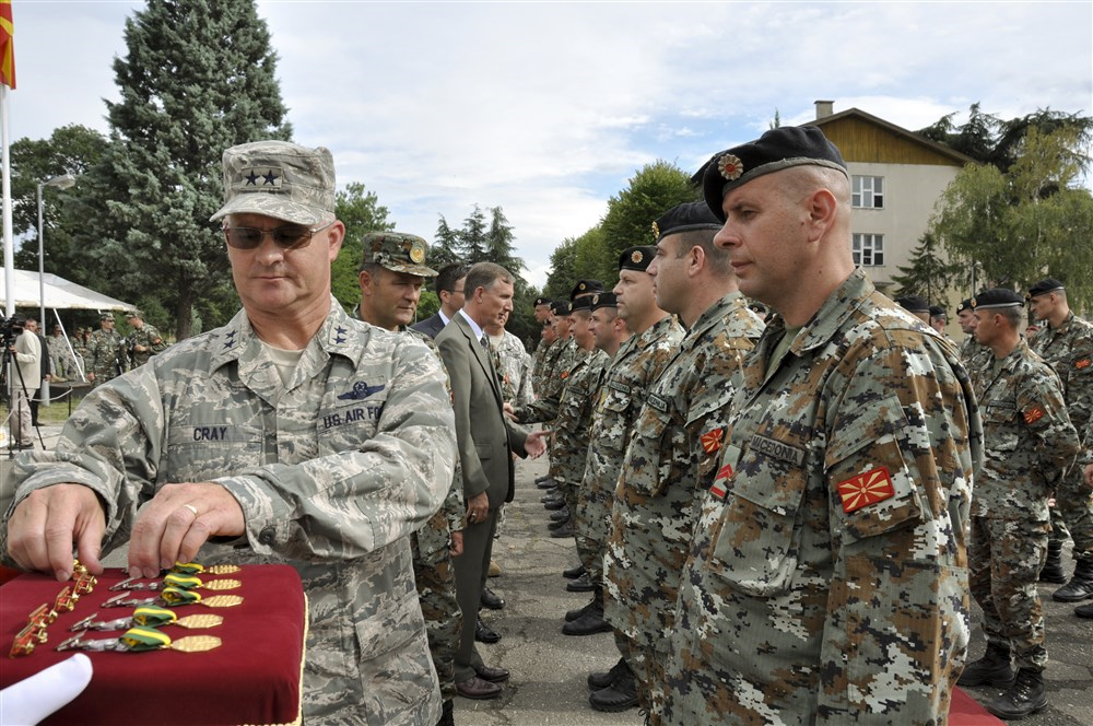 U.S. Air Force Maj. Gen. Steven Cray, the adjutant general of the Vermont National Guard, pins a medal on one of 79 soldiers from the army of Macedonia